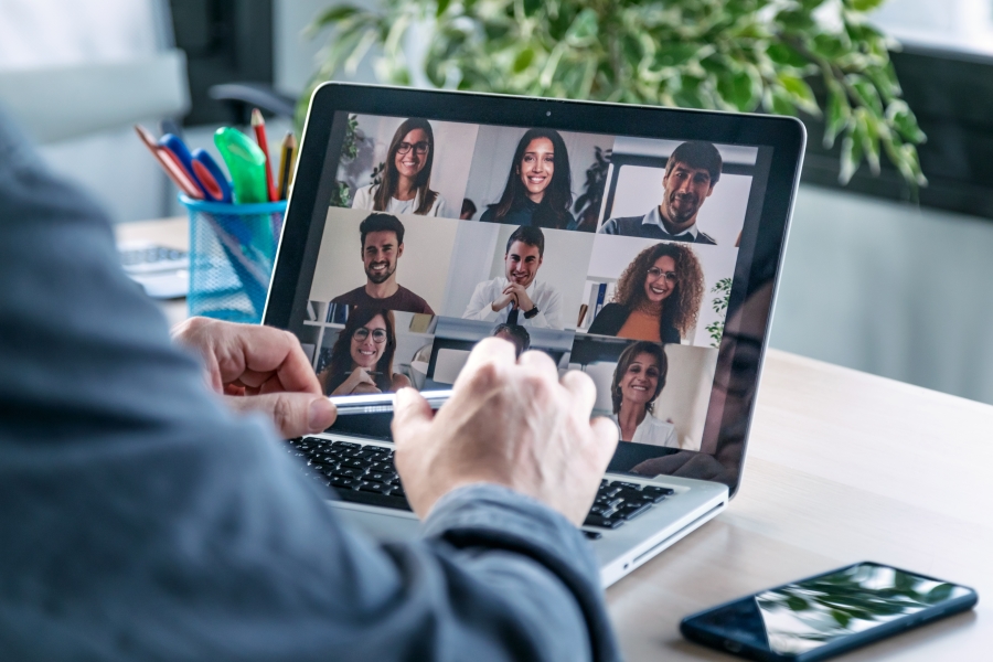 An image showing a group of people on a virtual video call via a laptop screen to represent Kazzicoms flexibility for in person or remote working
